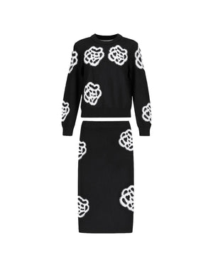Black sweater and skirt set with white floral patterns on a white background