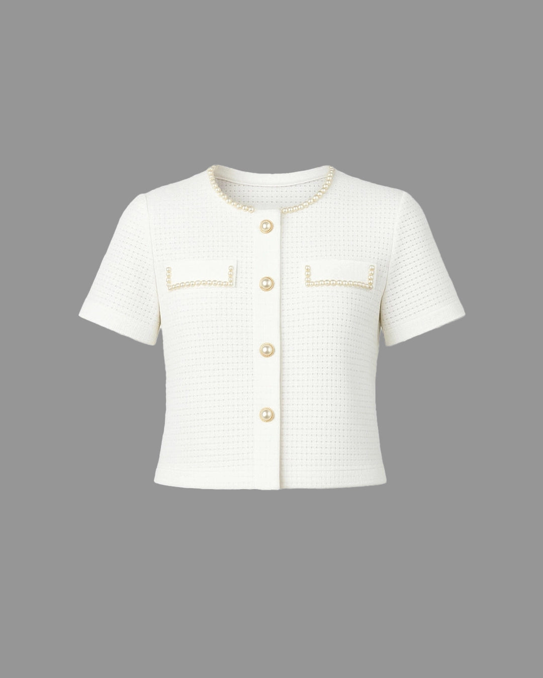 White short-sleeve jacket with gold buttons and trim on a gray background