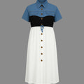 Color-blocked dress with blue, black, and white sections on a gray background