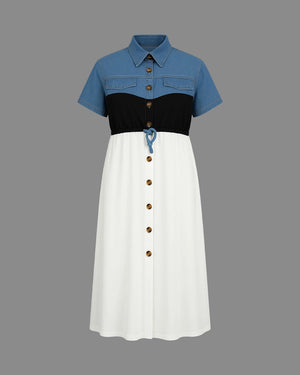 Color-blocked dress with blue, black, and white sections on a gray background