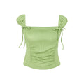Green top with ruched design and tied sleeves on a white background