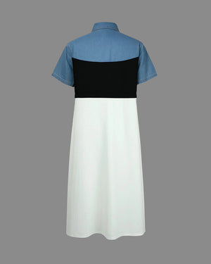 Dress with blue short sleeves and black and white panels on a gray background