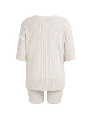 Beige ribbed top and shorts set on a white background