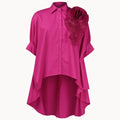 Pink blouse with a floral detail on a white background