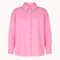 Pink shirt with decorative details on a white background