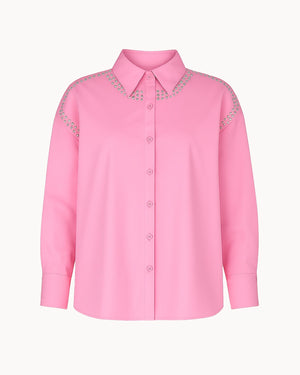 Pink shirt with decorative details on a white background