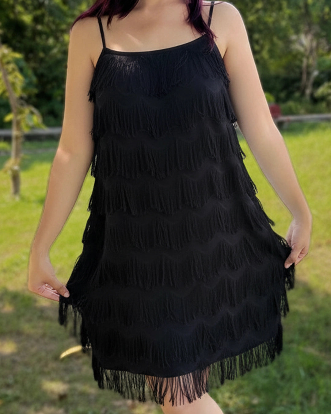 Black fringe dress worn by a person in an outdoor setting