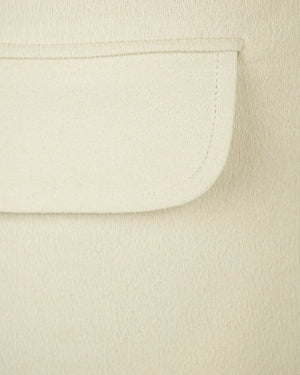 Close-up of a beige fabric with a pocket detail