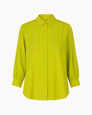 Yellow blouse with decorative elements on a white background