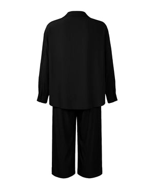 Black suit jacket and pants on a white background