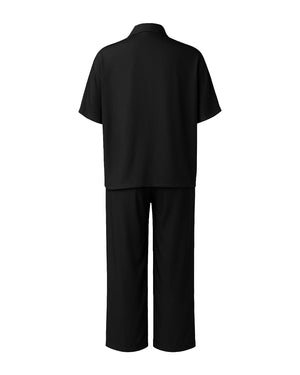 Black outfit with a shirt and wide-leg pants on a white background
