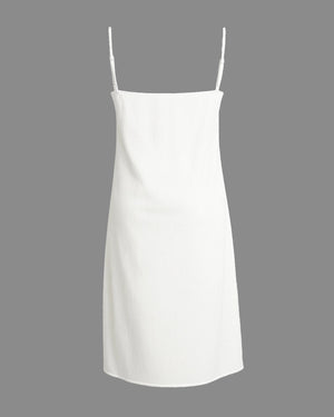 White slip dress with thin straps on a gray background