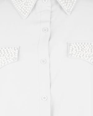 White shirt with decorative cut-out shoulders and sleeves on a white background