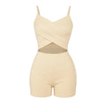 Beige romper with criss-cross detail on a white background