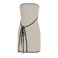 Beige strapless dress with black trim on a white background