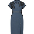 Blue denim dress with black floral embroidery on a white background