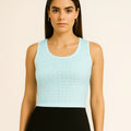 Woman wearing a light blue sleeveless top with a beige background and 'Bebo n Lolo' branding.