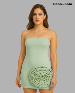 Woman wearing a light green strapless dress with a floral design on a gray background, branded 'Bebó n Lolo'.