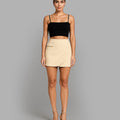 Woman wearing a black top and beige skirt with 'Bebó n Lolo' branding.
