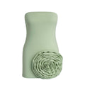 Green strapless top with a floral detail on a white background