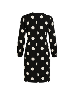 Black dress with white polka dots on a white background