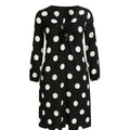 Black dress with white polka dots on a white background
