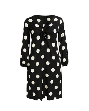 Black dress with white polka dots on a white background