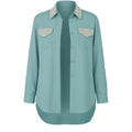 Teal shirt with embellished collar and pockets on a white background