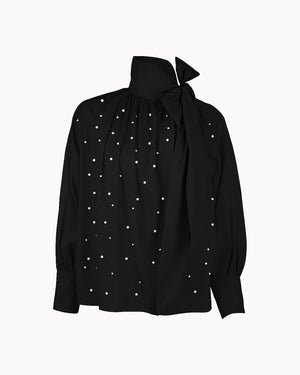 Black blouse with pearl embellishments on a white background