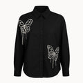 Black shirt with butterfly designs on a white background
