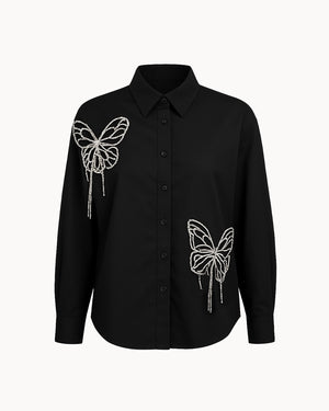 Black shirt with butterfly designs on a white background