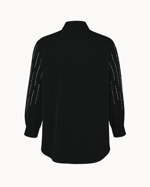 Black shirt with white embellishments on a white background