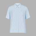 Light blue shirt with subtle pattern on a gray background