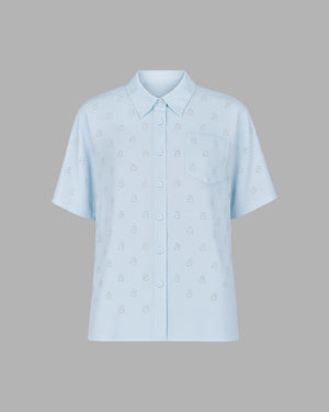 Light blue shirt with subtle pattern on a gray background
