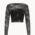 Black and gray long-sleeve top with sheer panels on a white background