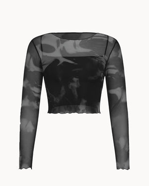 Black and gray long-sleeve top with sheer panels on a white background