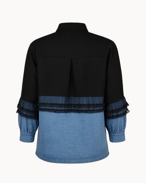 Black and blue shirt with sheer sleeves on a white background