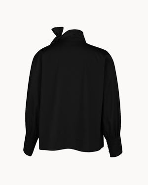 Black blouse with a bow detail on the back against a white background
