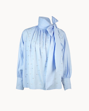 Light blue blouse with a tie detail on a white background