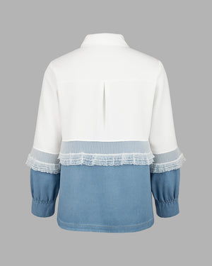 White and blue shirt with lace details on a gray background