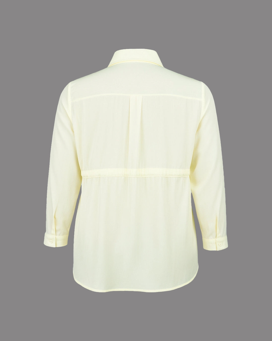 Light yellow shirt on a gray background