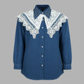 Blue shirt with white lace details on a gray background