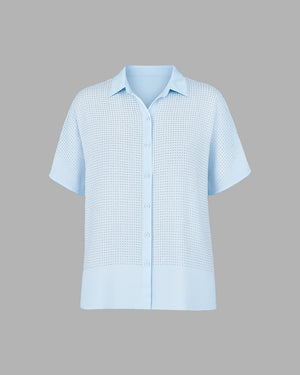 Light blue short-sleeve shirt with a subtle pattern on a gray background