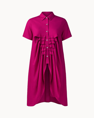 Fuchsia dress with ruffled details on a white background
