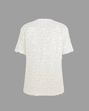 White sequin top on a gray background