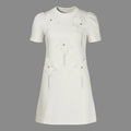 White dress with floral embellishments on a gray background