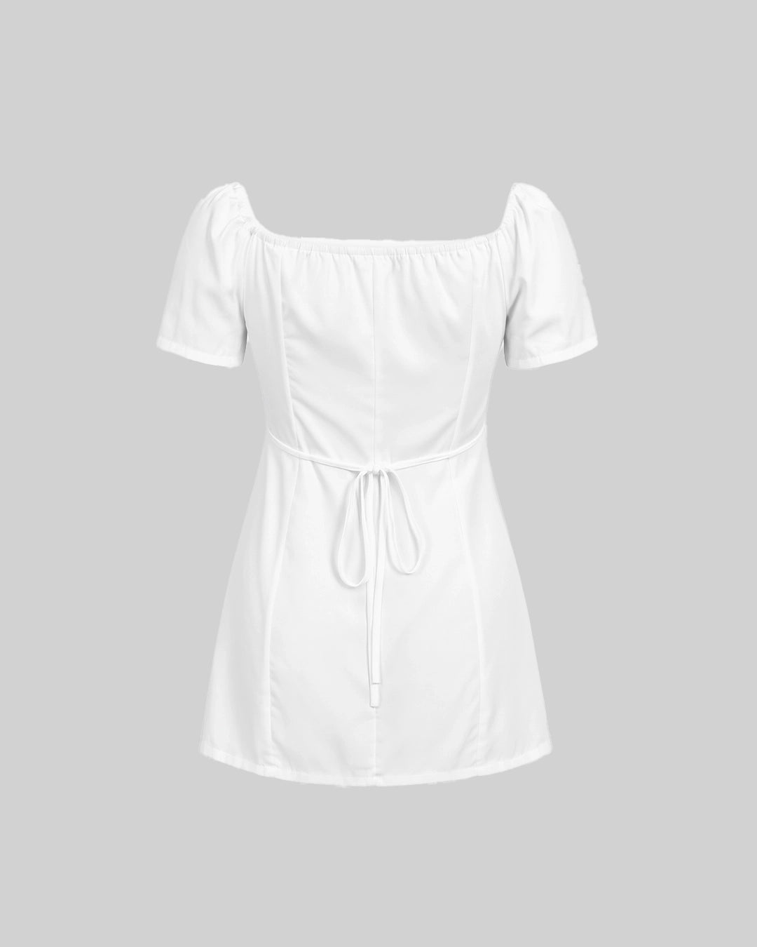 White off-shoulder dress on a gray background