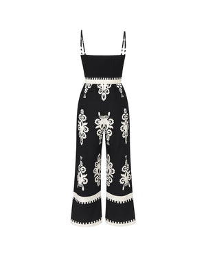 Black jumpsuit with white floral patterns on a white background