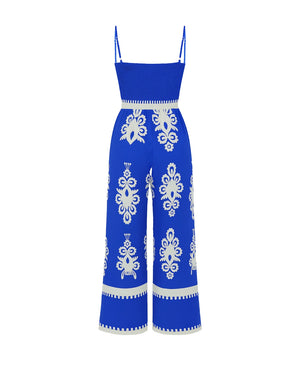 Blue jumpsuit with white patterns on a white background