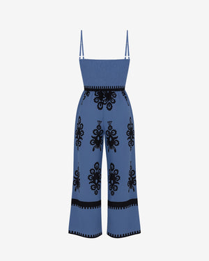Blue jumpsuit with black patterns on a white background